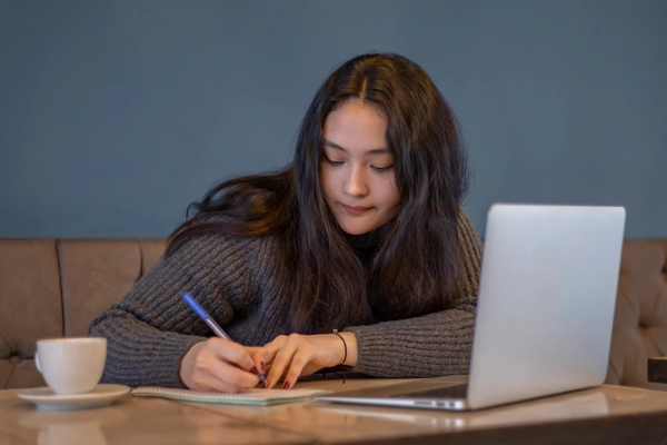 girl at a table doing her homework